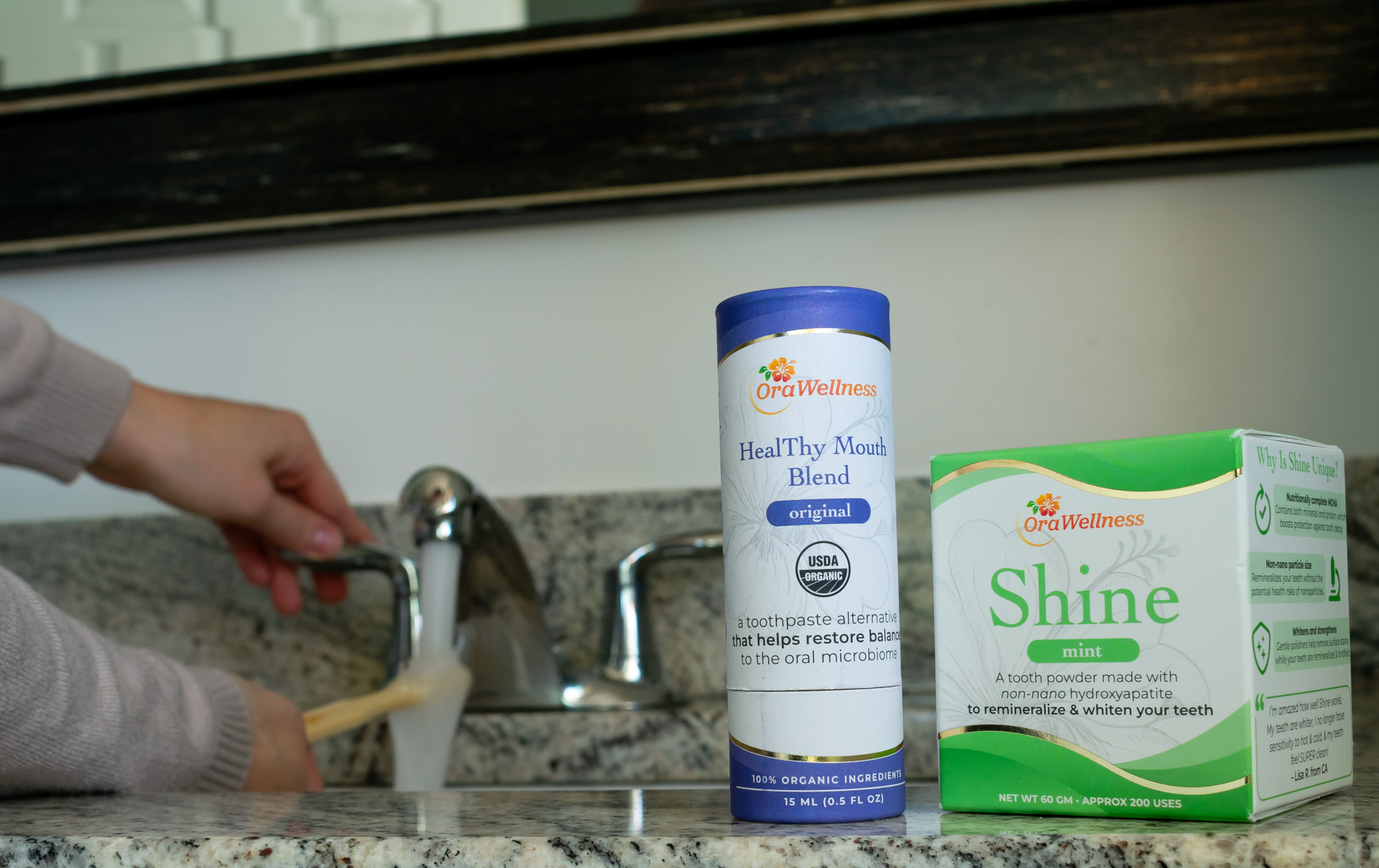 OraWellness HealThy Mouth Blend and OraWellness Shine sitting on a bathroom countertop