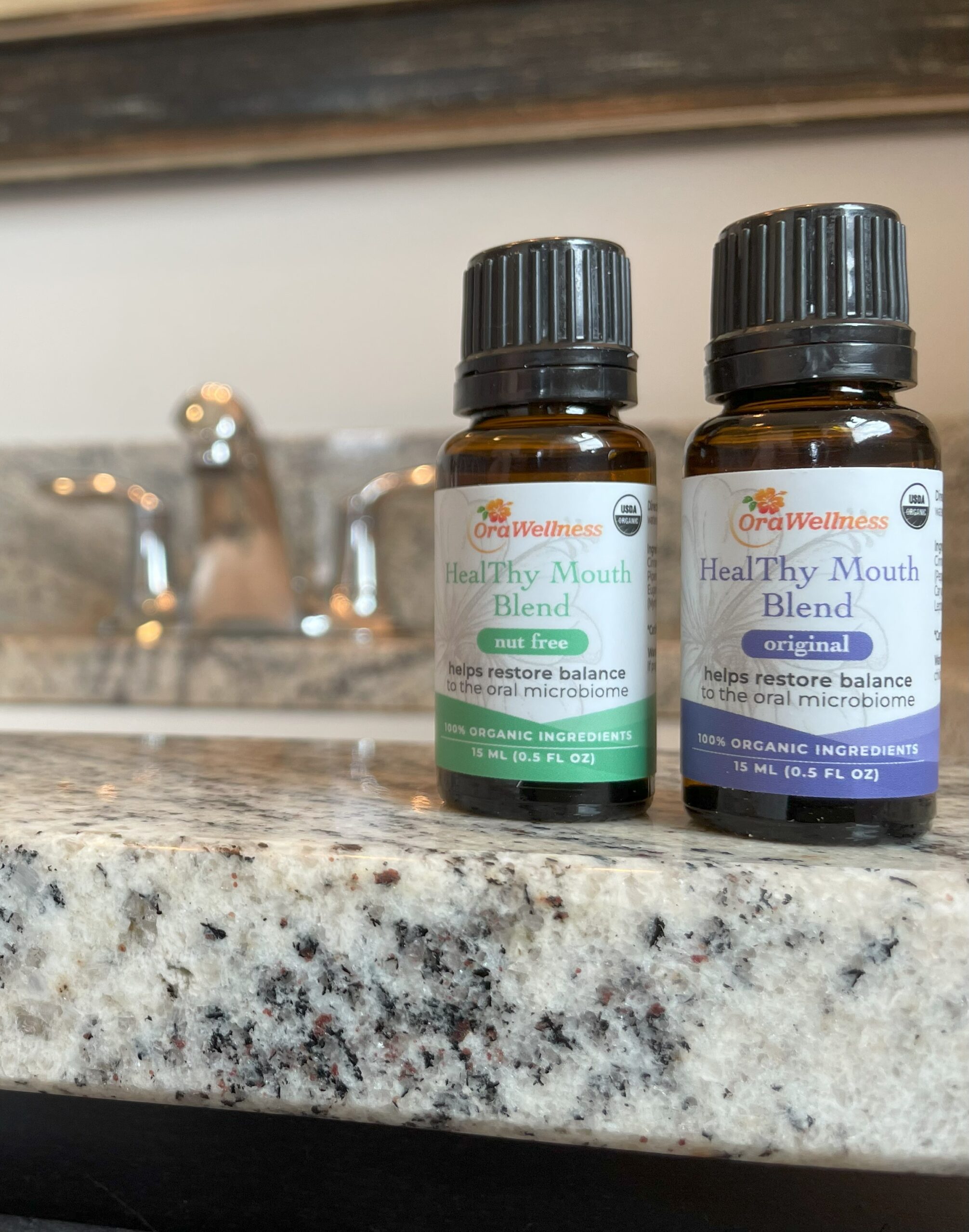Two bottles of HealThy Mouth Blend on the sink