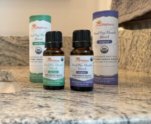 Two bottles of HealThy Mouth Blend and their containers on a sink