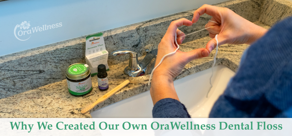 A picture of Awesome Floss and other OraWellness products on a bathroom counter plus hands forming a heart shape and holding some Awesome Floss string. This title is at the bottom of the image: Why We Created Our Own OraWellness Dental Floss
